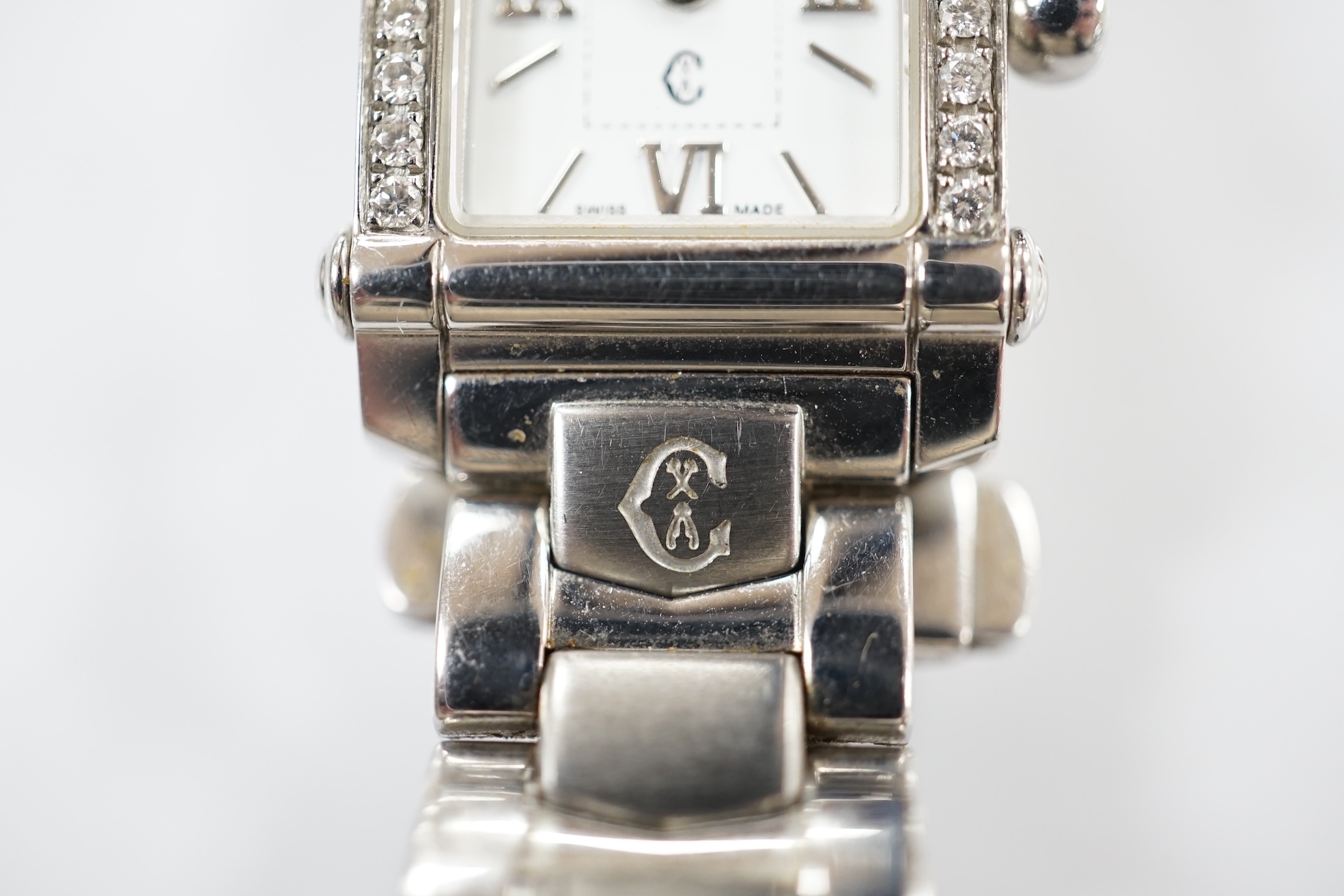 A lady's stainless steel Charriol Columbus quartz wrist watch with rectangular dial and diamond chip set bezel, on a stainless steel bracelet. Condition - fair